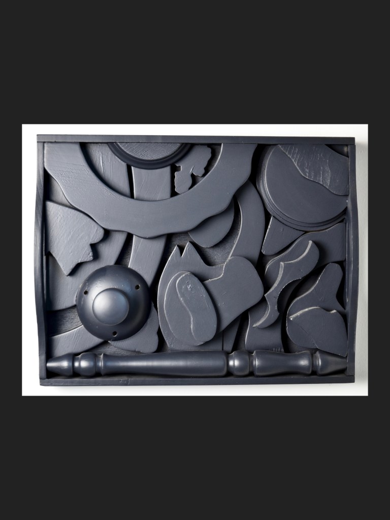 A wall sculpture in an arrangement of various abstract shapes and forms, including circular and curved elements, displayed in a rectangular tray, by David Furman