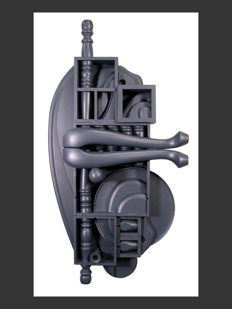 An abstract wall sculpture made from reclaimed wood featuring a combination of geometric and organic shapes in a gray color scheme by David Furman