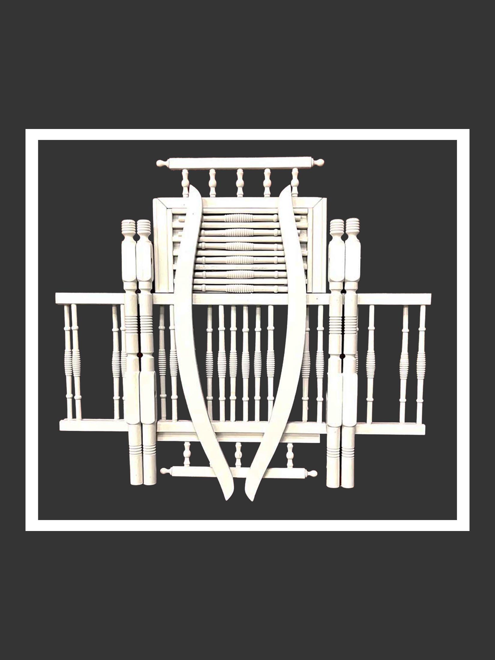 A unique artistic installation made of a deconstructed wooden baby crib painted white in a symmetrical and geometric re-imagining against a textured wall by David Furman.