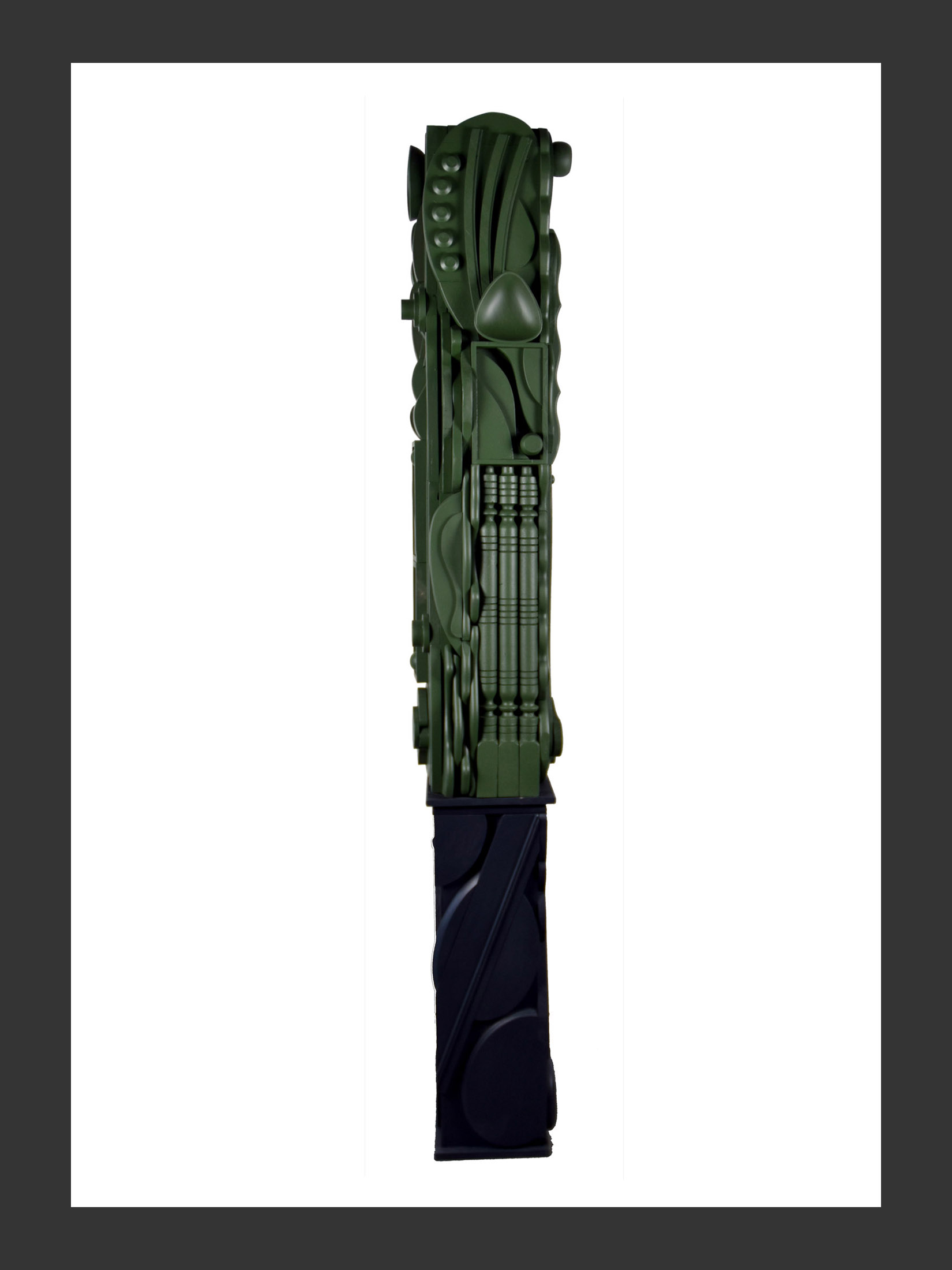 A long vertical sculpture made of reclaimed wooden elements with intricate designs and painted monochrome by David Furman