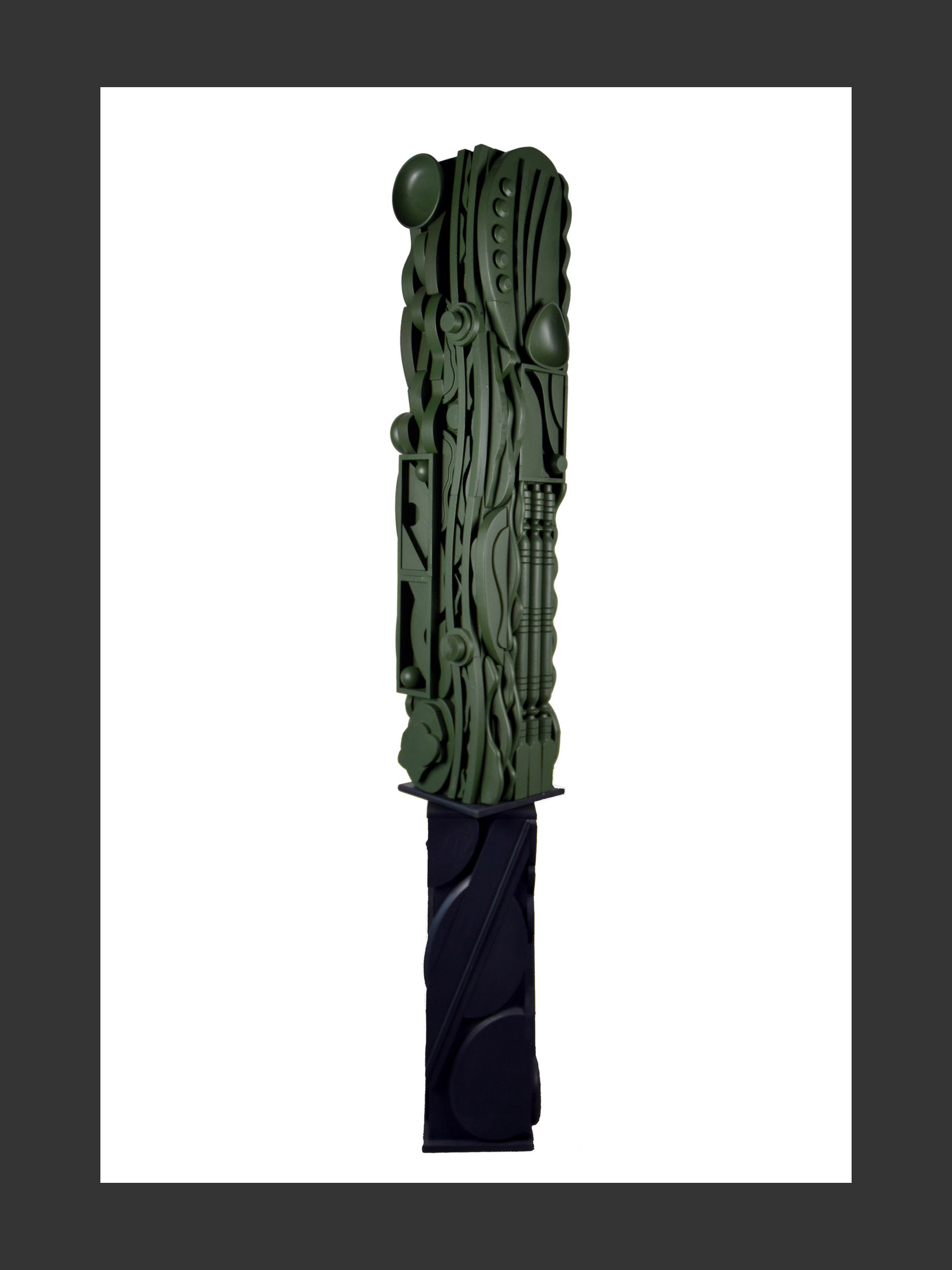 A vertical totem sculpture made from reclaimed wooden elements  with intricate designs, painted green on a darker base by David Furman