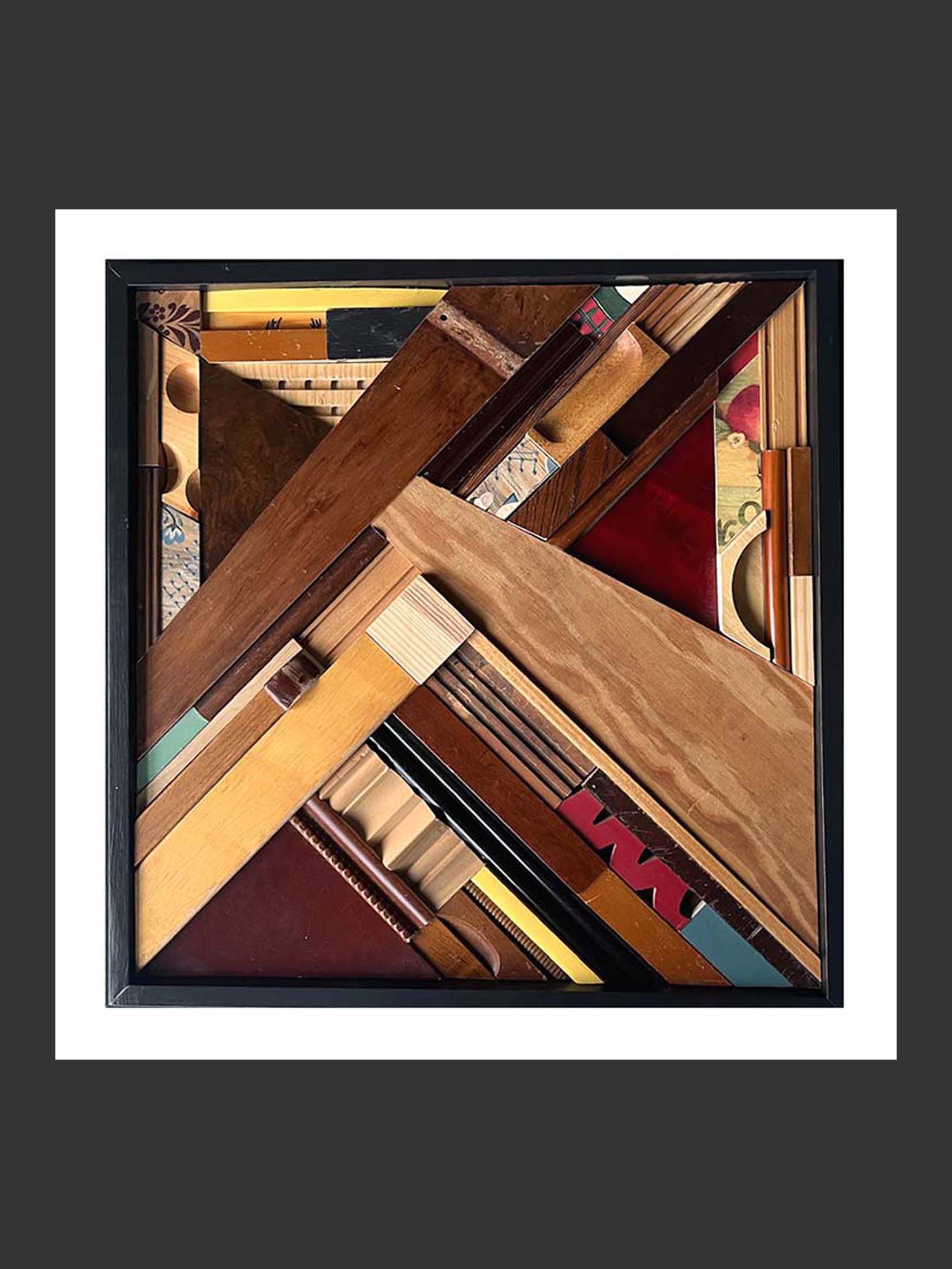 An intricate and abstract wooden collage made from reclaimed wood featuring various shapes and textures, arranged in a geometric pattern within a black frame by David Furman.