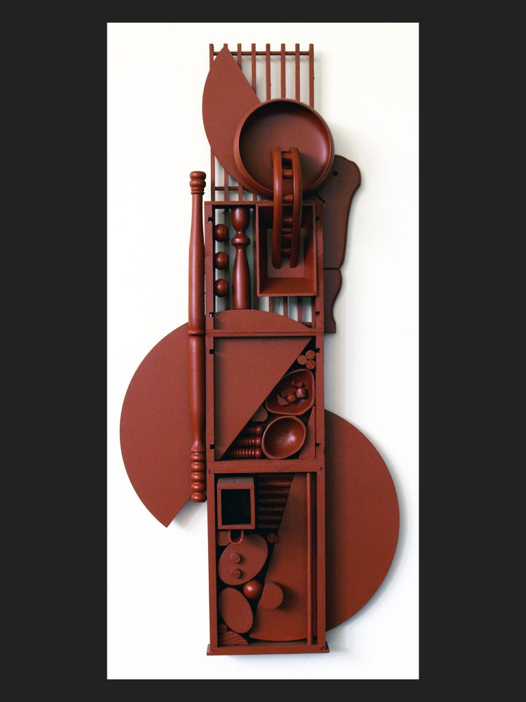 A vertical abstract art wall sculpture piece featuring various geometric shapes and forms in a reddish-brown color. The composition includes circular and rectangular elements arranged in a structured manner by David Furman