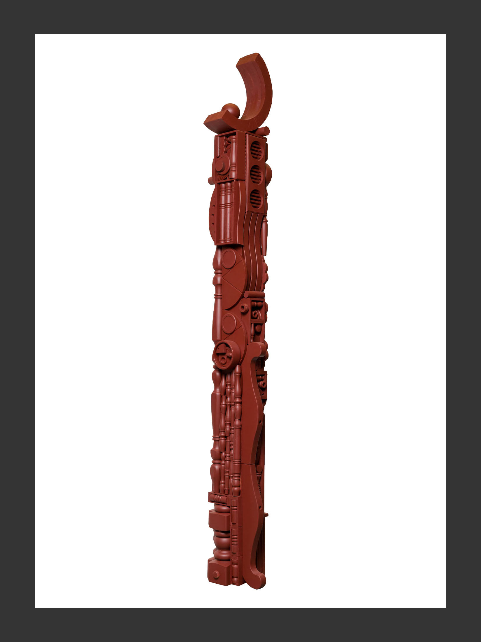 A vertical totem sculpture made from reclaimed wooden features and painted a reddish-brown color, placed against a simple background, by David Furman